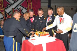 Honored military men cut into a King's Korner cake